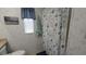 Bathroom featuring a nautical-themed shower curtain and window with blinds at 3333 26Th E Ave # 1257, Bradenton, FL 34208