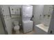 Bathroom featuring a stacked washer/dryer unit, toilet and a white sink at 3333 26Th E Ave # 1257, Bradenton, FL 34208