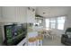 Charming dining area with white table set and bar seating, next to well-equipped kitchen and living area at 3333 26Th E Ave # 1257, Bradenton, FL 34208