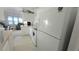 Well-lit kitchen featuring white appliances and cabinets, with view into a living space at 3333 26Th E Ave # 1257, Bradenton, FL 34208