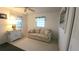 Bright living room features neutral walls, carpet, and a comfortable sofa with beachy accents at 3333 26Th E Ave # 1257, Bradenton, FL 34208
