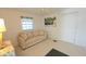 Bright living room features neutral walls, carpet, and a comfortable sofa with beachy accents at 3333 26Th E Ave # 1257, Bradenton, FL 34208