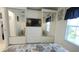 Main bedroom features a television, built-in storage, mirrored closet doors and a view to the bedroom at 3333 26Th E Ave # 1257, Bradenton, FL 34208