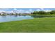 Beautiful lake and lush green lawn in the backyard of this home at 3512 Scrub Creek Run, Lakewood Ranch, FL 34211