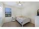 Cozy bedroom with natural light, a comfortable bed, and scenic outdoor views at 3512 Scrub Creek Run, Lakewood Ranch, FL 34211