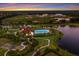 A stunning aerial view of the community pool and park area, situated next to a serene lake at 3512 Scrub Creek Run, Lakewood Ranch, FL 34211
