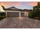 A charming, single-story home featuring a two-car garage and a beautiful brick driveway at 3512 Scrub Creek Run, Lakewood Ranch, FL 34211