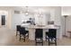 Open-concept kitchen featuring granite countertops, bar seating, and stainless steel appliances, perfect for entertaining at 3512 Scrub Creek Run, Lakewood Ranch, FL 34211
