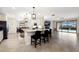 Spacious kitchen featuring tile floors, neutral walls, white cabinets, and an island with barstools at 3512 Scrub Creek Run, Lakewood Ranch, FL 34211