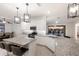 A bright kitchen features white cabinets, granite countertops, stainless appliances, and a view to the screened-in pool at 3512 Scrub Creek Run, Lakewood Ranch, FL 34211