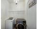 Laundry room includes washer, dryer, shelving, and a decorative chandelier at 3512 Scrub Creek Run, Lakewood Ranch, FL 34211