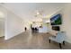 Open living room with tile flooring and a view to the kitchen and eating area at 3512 Scrub Creek Run, Lakewood Ranch, FL 34211