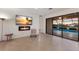 Open living space with access to the pool, featuring a modern fireplace and elegant decor at 3512 Scrub Creek Run, Lakewood Ranch, FL 34211