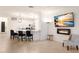 Bright living room featuring a fireplace, modern decor, and an open view of the kitchen with bar seating at 3512 Scrub Creek Run, Lakewood Ranch, FL 34211