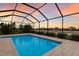 Relaxing screened-in pool offers stunning lake views, creating a perfect outdoor oasis for unwinding at 3512 Scrub Creek Run, Lakewood Ranch, FL 34211