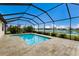 A screened-in pool and patio offer a beautiful view of a lake in the backyard at 3512 Scrub Creek Run, Lakewood Ranch, FL 34211