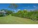 Private backyard featuring a manicured lawn and a tall hedge for privacy and landscaping at 3522 Ferndell, Sarasota, FL 34235