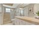 Bathroom showcasing a tiled walk-in shower, toilet, sink with vanity and a large mirror at 3522 Ferndell, Sarasota, FL 34235