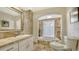 Inviting bathroom with a soaking tub, neutral stone tile, and abundant natural light at 3522 Ferndell, Sarasota, FL 34235