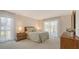 Serene bedroom with natural light from large windows, neutral decor, and plush carpeting at 3522 Ferndell, Sarasota, FL 34235
