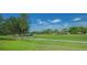 Lush green golf course with mature trees under blue skies offering a serene setting at 3522 Ferndell, Sarasota, FL 34235