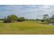 Expansive golf course with a vibrant green fairway, a water hazard, and blue skies at 3522 Ferndell, Sarasota, FL 34235