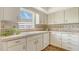 Charming kitchen featuring tiled backsplash, stone countertops, and updated appliances under natural light at 3522 Ferndell, Sarasota, FL 34235