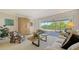 Bright living room featuring neutral colors, large windows, and access to the outdoor patio at 3522 Ferndell, Sarasota, FL 34235