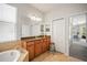 Bathroom featuring tile floors, double sinks with granite countertops, a stool, and large vanity mirrors at 358 River Enclave Ct, Bradenton, FL 34212