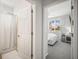 Comfortable bedroom with bright window offering natural light, seamlessly connected to a nearby bathroom for added convenience at 358 River Enclave Ct, Bradenton, FL 34212