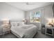 Serene bedroom featuring a plush bed, a sunlit window, and a cozy desk area for a relaxing and functional space at 358 River Enclave Ct, Bradenton, FL 34212