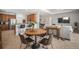 Open-concept dining room with a kitchen island, a breakfast bar, and views into the living room at 358 River Enclave Ct, Bradenton, FL 34212