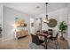 Cozy dining room with a wooden table, rug, modern light fixture, and decorative wall art at 358 River Enclave Ct, Bradenton, FL 34212