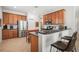 Well-equipped kitchen boasting wood cabinets, stainless steel appliances, breakfast bar and plenty of counter space at 358 River Enclave Ct, Bradenton, FL 34212