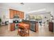 Kitchen featuring wooden cabinets, stainless steel appliances, and a granite countertop with access to the outdoor dining area at 358 River Enclave Ct, Bradenton, FL 34212