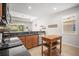 Bright kitchen with stainless steel appliances, granite countertops and wooden cabinets with an island on wheels at 358 River Enclave Ct, Bradenton, FL 34212