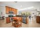 Kitchen featuring wooden cabinets, stainless steel appliances, granite countertops, and an island with views to the patio at 358 River Enclave Ct, Bradenton, FL 34212