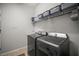 Modern laundry room featuring front loading washer and dryer with ample storage for efficient and organized laundry care at 358 River Enclave Ct, Bradenton, FL 34212