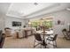 Inviting living space featuring a table, tile floors, and an outdoor screened in patio at 358 River Enclave Ct, Bradenton, FL 34212