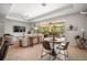 Bright living area with tile floors, casual seating, and sliding doors to the screened lanai at 358 River Enclave Ct, Bradenton, FL 34212