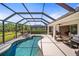 Inviting screened-in pool and spa with ample patio space for outdoor living and dining, accessed through sliding glass doors at 358 River Enclave Ct, Bradenton, FL 34212