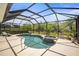 Private screened-in pool and spa with a spacious patio, offering a serene and secluded outdoor oasis surrounded by greenery at 358 River Enclave Ct, Bradenton, FL 34212