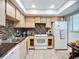 Kitchen features wood floors, tile backsplash, and white appliances at 3602 Beneva Rd # 405, Sarasota, FL 34239