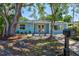 Charming home featuring vibrant landscaping, mature trees, and a cozy entrance at 3728 Rilma Ave, Sarasota, FL 34234