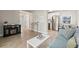 Open-concept living room with wood-look flooring, modern fireplace, and stainless steel appliances at 3728 Rilma Ave, Sarasota, FL 34234