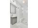 Modern bathroom features a glass enclosed shower with marble style tile and a floating vanity with sleek fixtures at 3856 Monica Pkwy, Sarasota, FL 34235