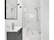 Modern bathroom features glass enclosed shower with dual shower heads, marble style tile and floating vanity at 3856 Monica Pkwy, Sarasota, FL 34235