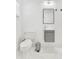 Modern bathroom featuring a sleek vanity, toilet, and stylish mirror at 3856 Monica Pkwy, Sarasota, FL 34235