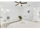 Bright bedroom featuring a modern ceiling fan, adjacent bathroom, and walk-in closet at 3856 Monica Pkwy, Sarasota, FL 34235