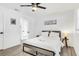 Cozy bedroom featuring a comfortable bed, modern ceiling fan, and simple decor at 3856 Monica Pkwy, Sarasota, FL 34235